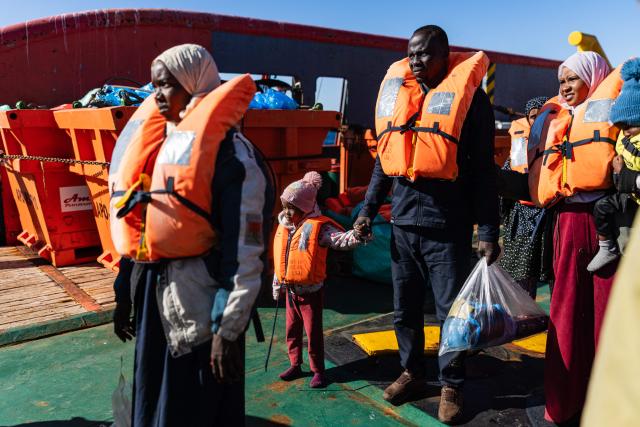 Migrants prepare to board a RHIB (Rigid inflatable boat) as crew members of the “Ocean Viking” rescue ship evacuate them from the oil tanker the 'Maridive 703' in the search-and-rescue zone of the international waters between Malta and Tunisia, on December 31, 2025. 33 migrants were rescued by crew members of the migrants rescue ship "Ocean Viking" operated by the French NGO SOS Mediterranee. They had been stranded on the oil tanker the 'Maridive 703' since their initial rescue 5 days ago in the joint search zone between Malta and Tunisia in international Mediterranean waters. (Photo by Sameer Al-DOUMY / AFP)