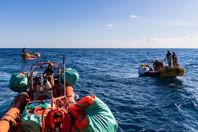 Crew members of the “Ocean Viking” rescue ship prepare to evacuate migrants to RHIBs (Rigid inflatable boat) from the oil tanker the Maridive 703, in the search-and-rescue zone in international waters between Malta and Tunisia, on December 31, 2025. 33 migrants were rescued by crew members of the migrants rescue ship "Ocean Viking" operated by the French NGO SOS Mediterranee. They had been stranded on the oil tanker the 'Maridive 703' since their initial rescue 5 days ago in the joint search zone between Malta and Tunisia in international Mediterranean waters. (Photo by Sameer Al-DOUMY / AFP)