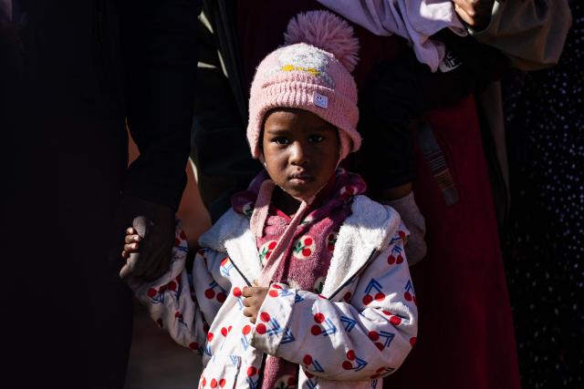 A young girl looks on as migrants prepare to board a RHIB (Rigid inflatable boat) as they are evacuated from the oil tanker the 'Maridive 703' by crew members of the “Ocean Viking” rescue ship in the search-and-rescue zone of the international waters between Malta and Tunisia, on December 31, 2025. 33 migrants were rescued by crew members of the migrants rescue ship "Ocean Viking" operated by the French NGO SOS Mediterranee. They had been stranded on the oil tanker the 'Maridive 703' since their initial rescue 5 days ago in the joint search zone between Malta and Tunisia in international Mediterranean waters. (Photo by Sameer Al-DOUMY / AFP)