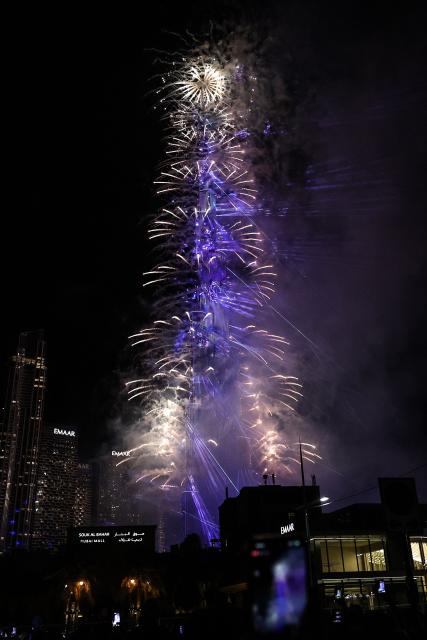 Fireworks light up the sky around the Burj Khalifa Tower, as the UAE welcomes in the New Year, in Dubai on January 1, 2026. (Photo by Fadel SENNA / AFP)