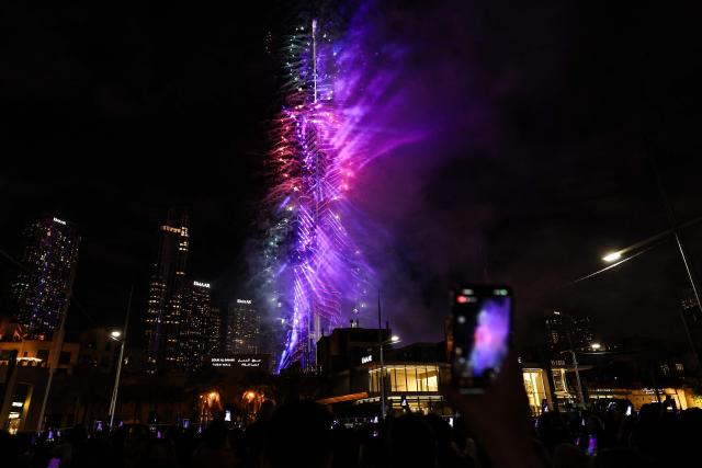 Fireworks light up the sky around the Burj Khalifa Tower, as the UAE welcomes in the New Year, in Dubai on January 1, 2026. (Photo by Fadel SENNA / AFP)