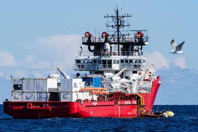 A RHIB (Rigid inflatable boat) carrying migrants evacuated from the oil tanker the 'Maridive 703' docks with the “Ocean Viking” rescue ship, operated by the NGO SOS Mediterranee, in the search-and-rescue zone of the international waters between Malta and Tunisia, on December 31, 2025. 33 migrants were rescued by crew members of the migrants rescue ship "Ocean Viking" operated by the French NGO SOS Mediterranee. They had been stranded on the oil tanker the 'Maridive 703' since their initial rescue 5 days ago in the joint search zone between Malta and Tunisia in international Mediterranean waters. (Photo by Sameer Al-DOUMY / AFP)