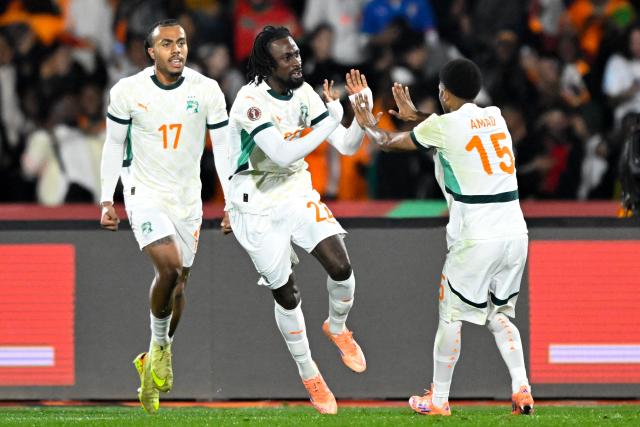 Ivory Coast's forward #22 Evann Guessand (C) celebrates scoring his team's second goal with Ivory Coast's defender #17 Guela Doue and Ivory Coast's forward #15 Amad Diallo during the Africa Cup of Nations (CAN) Group F football match between Gabon and Ivory Coast at the Grand Stadium in Marrakech on December 31, 2025. (Photo by Khaled DESOUKI / AFP)