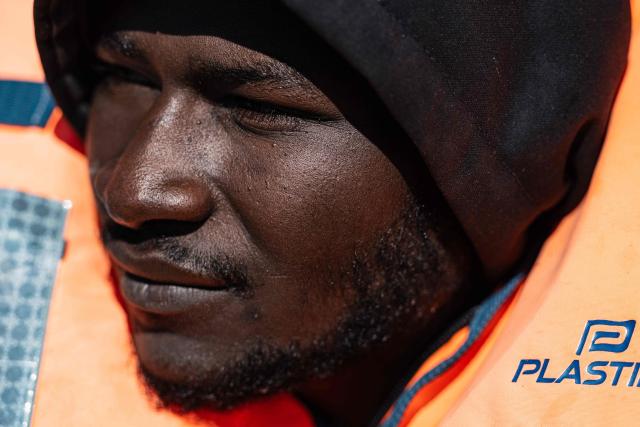 A migrant looks on as he sits onboard a RHIB (Rigid inflatable boat) after being evacuated by crew members of the “Ocean Viking” rescue ship, operated by the NGO SOS Mediterranee, from the oil tanker the 'Maridive 703' in the search-and-rescue zone of the international waters between Malta and Tunisia, on December 31, 2025. 33 migrants were rescued by crew members of the migrants rescue ship "Ocean Viking" operated by the French NGO SOS Mediterranee. They had been stranded on the oil tanker the 'Maridive 703' since their initial rescue 5 days ago in the joint search zone between Malta and Tunisia in international Mediterranean waters. (Photo by Sameer Al-DOUMY / AFP)