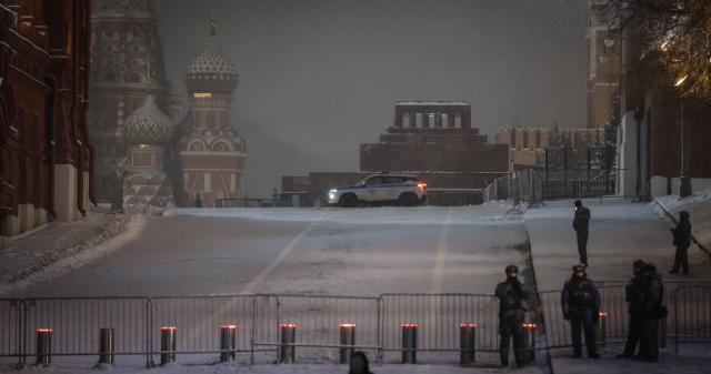 Law enforcement officers patrol around the closed Red Square during the New Year's Eve celebrations in Moscow on December 31, 2025. (Photo by TATYANA MAKEYEVA / AFP)
