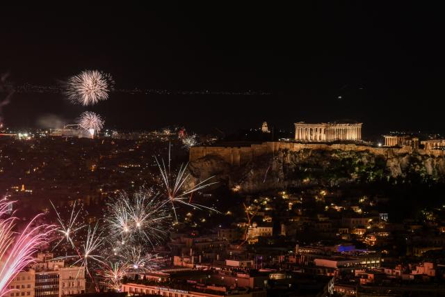 Fireworks explode next to the ancient Parthenon temple atop the Acropolis during New Year celebrations in Athens, early on January 1, 2026. (Photo by Angelos TZORTZINIS / AFP)