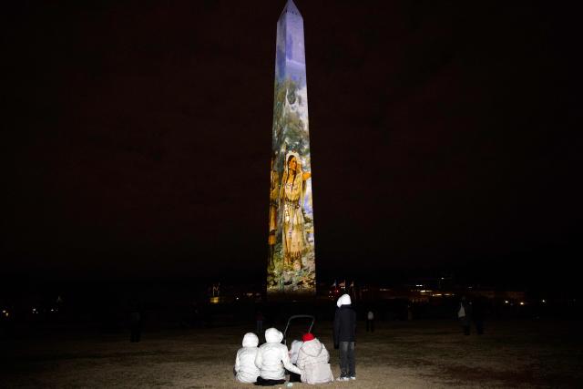 The Washington Monument is illuminated with a projection of US President Donald Trump's "Freedom 250" initiative during the New Year's Eve show at the National Mall in Washington, DC on December 31, 2025. The Washington Monument is illuminated to start the beginning of a momentous year for the US, as it marks 250 years since the Declaration of Independence was signed. (Photo by Amid FARAHI / AFP)
