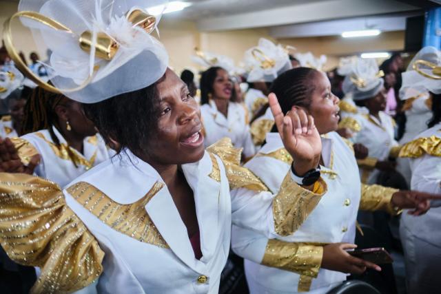 Women sing praise songs moments after midnight during a crossover service at the SPIF Synagogue in Bulawayo on January 1, 2026. (Photo by Zinyange Auntony / AFP)