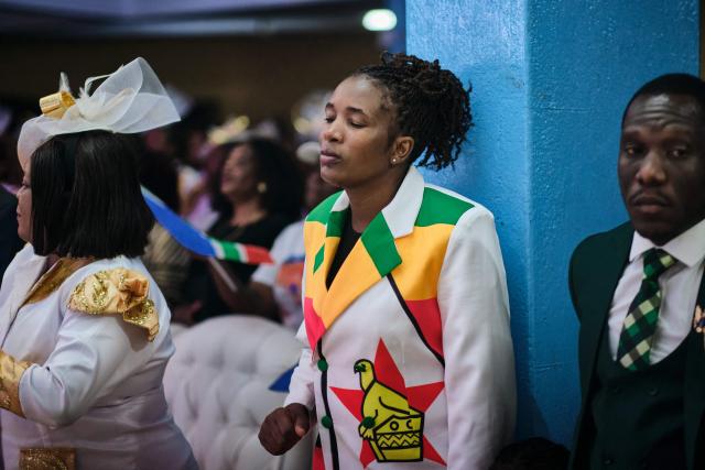 TOPSHOT - A woman prays moments after midnight during a crossover service at the SPIF Synagogue in Bulawayo on January 1, 2026. (Photo by Zinyange Auntony / AFP)
