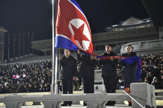 This picture shows a flag-raising ceremony to welcome in the new year at Kim Il Sung Square in Pyongyang on December 31, 2025. (Photo by KIM Won Jin / AFP)