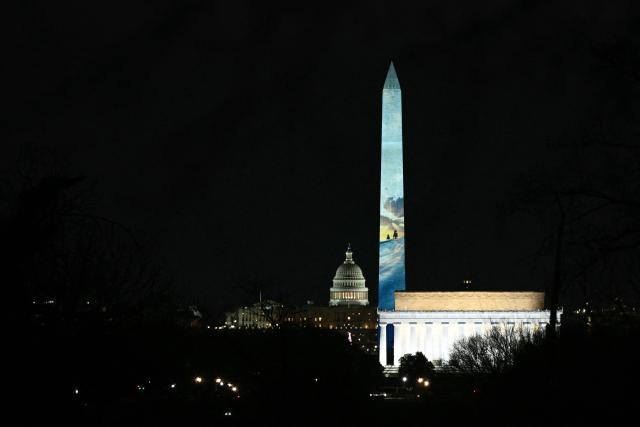 The Washington Monument is illuminated with a projection of US President Donald Trump's "Freedom 250" initiative during the New Year's Eve show at the National Mall in Washington, DC on December 31, 2025. The Washington Monument is illuminated to start the beginning of a momentous year for the US, as it marks 250 years since the Declaration of Independence was signed. (Photo by Brendan SMIALOWSKI / AFP)
