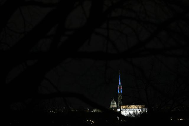 The Washington Monument is illuminated with a projection of US President Donald Trump's "Freedom 250" initiative during the New Year's Eve show at the National Mall in Washington, DC on December 31, 2025. The Washington Monument is illuminated to start the beginning of a momentous year for the US, as it marks 250 years since the Declaration of Independence was signed. (Photo by Brendan SMIALOWSKI / AFP)