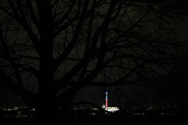 The Washington Monument is illuminated with a projection of US President Donald Trump's "Freedom 250" initiative during the New Year's Eve show at the National Mall in Washington, DC on December 31, 2025. The Washington Monument is illuminated to start the beginning of a momentous year for the US, as it marks 250 years since the Declaration of Independence was signed. (Photo by Brendan SMIALOWSKI / AFP)