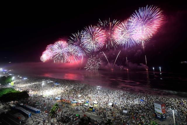 Fireworks to celebrate the New Year explode on Copacabana Beach during celebrations in Rio de Janeiro, Brazil, on January 1, 2026. Rio de Janeiro received, on December 30, 2025, the title of the world’s largest New Year’s Eve celebration from the Guinness World Records, a recognition of its famous massive festivity with live music shows by the sea. (Photo by Daniel RAMALHO / AFP)