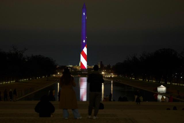 The Washington Monument is illuminated with a projection of US President Donald Trump's "Freedom 250" initiative during the New Year's Eve show at the National Mall in Washington, DC on December 31, 2025. The Washington Monument is illuminated to start the beginning of a momentous year for the US, as it marks 250 years since the Declaration of Independence was signed. (Photo by Amid FARAHI / AFP)