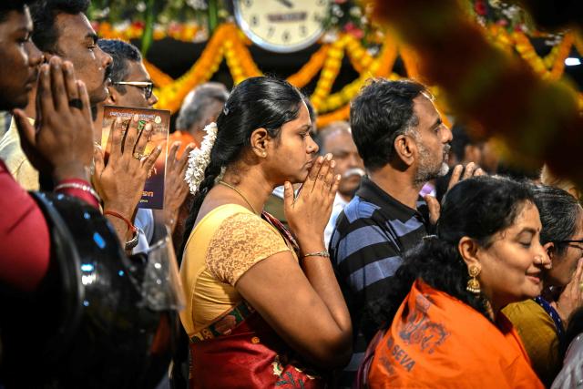Hindu devotees offer prayers on New Year's Day at a temple in Chennai on January 1, 2026. (Photo by R.Satish BABU / AFP)