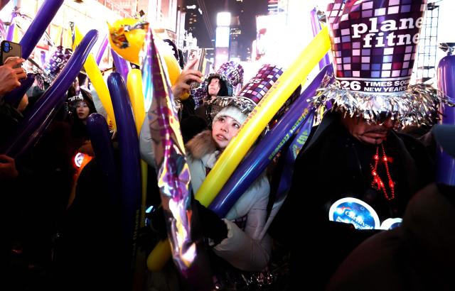 People attend the New Year's Eve celebrations and ball drop in Times Square in New York on January 1, 2026. (Photo by John Lamparski / AFP)