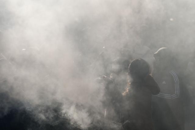 People burn incense sticks and offer prayers at Yonghe Temple, also known as Lama Temple, on the first day of the new year in Beijing on January 1, 2026. (Photo by WANG Zhao / AFP)