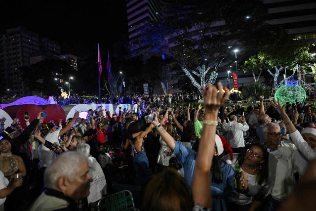People celebrate the arrival of the New Year in Caracas, Venezuela, on January 1, 2026. (Photo by Juan BARRETO / AFP)