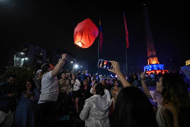People celebrate the arrival of the New Year in Caracas, Venezuela, on January 1, 2026. (Photo by Juan BARRETO / AFP)