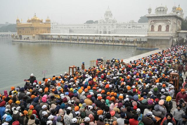 Sikh devotees gather to pray at the Golden Temple on New Year's Day in Amritsar on January 1, 2026. (Photo by Narinder NANU / AFP)
