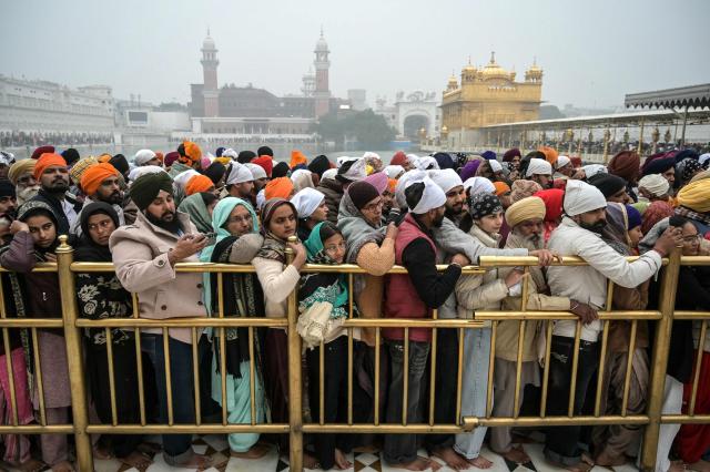 Sikh devotees gather to pray at the Golden Temple on New Year's Day in Amritsar on January 1, 2026. (Photo by Narinder NANU / AFP)