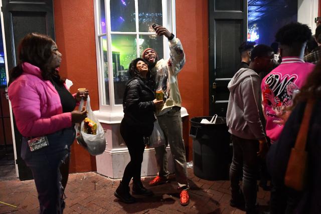 A couple snaps a selfie while celebrating the New Year at the French Quarter in New Orleans, Louisiana, on January 1, 2026. (Photo by Octavio JONES / AFP)