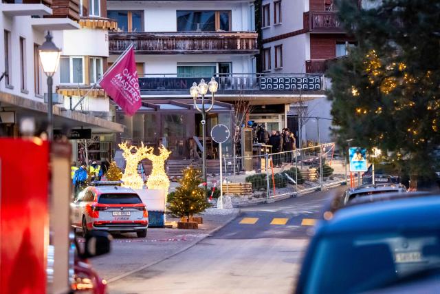 Rescuers and people are seen at the site of an explosion that ripped through a bar in Crans-Montana on January 1, 2026. Several people were killed and others injured when an explosion ripped through a bar in the luxury Alpine ski resort town of Crans Montana, Swiss police said early on January 1. (Photo by MAXIME SCHMID / AFP)