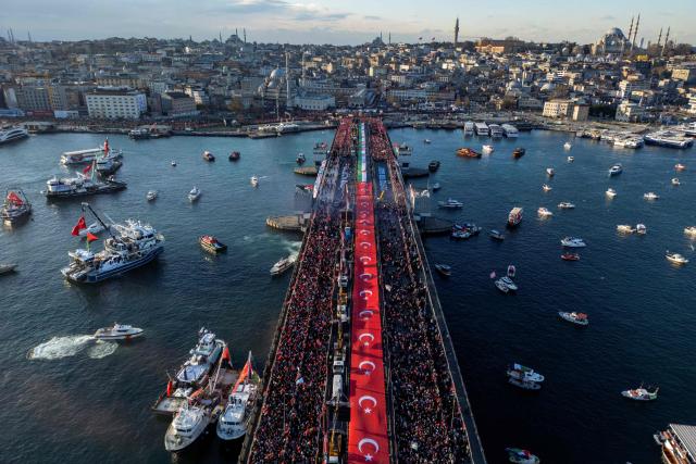 This aerial picture shows thousands of people demonstrating their solidarity with the Palestinian people amid the ongoing war between Israel and the Palestinian Hamas group in the Gaza enclave, at the Galata Bridge in Istanbul on January 1, 2026. (Photo by Yasin AKGUL / AFP)