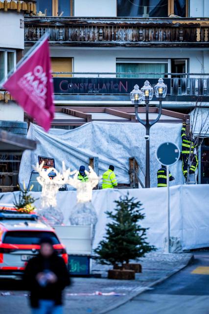 Rescuers and fire-fighters work at the site of an explosion that ripped through a bar in Crans-Montana on January 1, 2026. Several people were killed and others injured when an explosion ripped through a bar in the luxury Alpine ski resort town of Crans Montana, Swiss police said early on January 1. (Photo by MAXIME SCHMID / AFP)