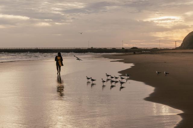 A holidaymaker walks on the South beach on New Year's day in Durban on January 1, 2026. (Photo by RAJESH JANTILAL / AFP)