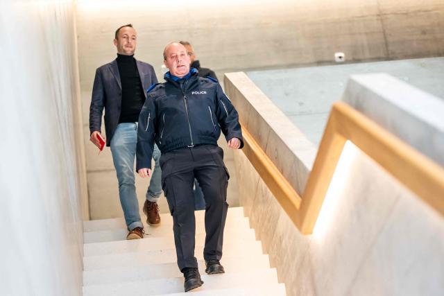 Commander of the Valais cantonal police Frederic Gisler, arrives for a press conference following an explosion that ripped through the bar Le Constellation in the luxury Alpine ski resort town of Crans-Montana, on January 1, 2026. "Several dozen" people are believed to have died and around 100 were injured when a fire ripped through a crowded bar in the luxury Swiss ski resort town of Crans-Montana, police said January 1. (Photo by MAXIME SCHMID / AFP)