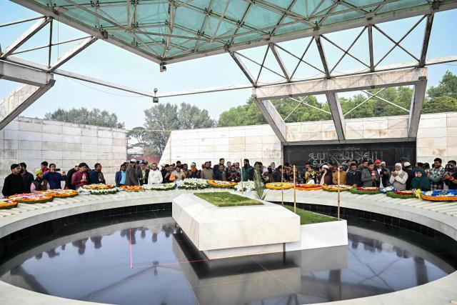 Supporters of the Bangladesh Nationalist Party (BNP) and mourners gather around the grave of former prime minister Khaleda Zia in Dhaka on January 1, 2026. Bangladesh bid farewell on December 31, 2025 to former prime minister Khaleda Zia in a state funeral that drew vast crowds mourning a towering leader whose career defined the country's politics for decades. (Photo by Munir UZ ZAMAN / AFP)