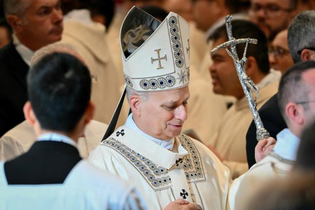 Pope Leo XIV leaves after a Holy Mass for the Solemnity of Mary Mother of God as part of the New Year's celebrations in St. Peter's Basilica, at the Vatican, on January 1, 2026. (Photo by Alberto PIZZOLI / AFP)