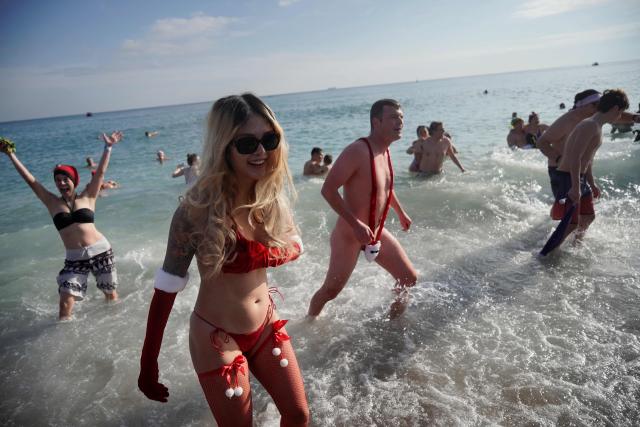 Swimmers celebrate New Year's Day by taking a traditional first bath of the year at Sant Sebastia beach in Barceloneta neighbourhood, Barcelona, on January 1, 2026. (Photo by Manaure Quintero / AFP)