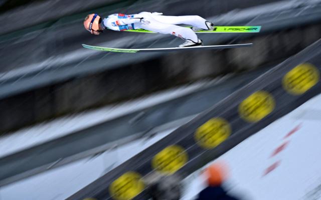 Austria's Stefan Kraft soars through the air during the trial round ahead of the Men's Individual Large Hill HS142 event of the FIS Ski Jumping World Cup, the second leg of the Four Hills Tournament, in Garmisch-Partenkirchen, southern Germany on January 1, 2026. (Photo by PHILIPP GUELLAND / AFP)