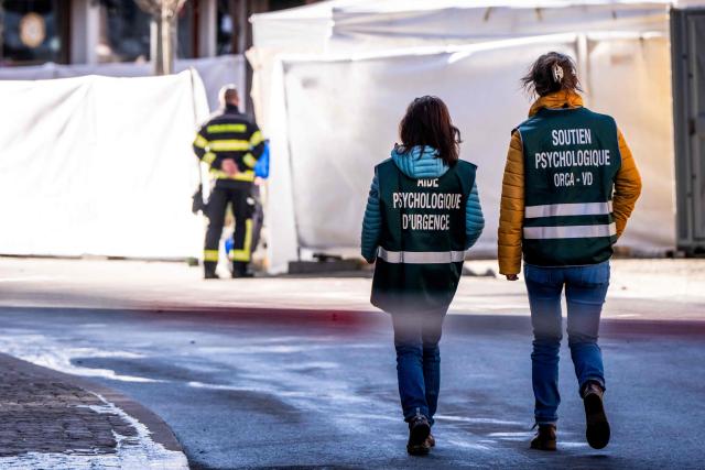 Members of the Emergency psychological support arrive at the bar Le Constellation following an explosion that ripped the venue in Crans-Montana, in January 1, 2026 during New Year's Eve celebrations. Several dozen people are presumed dead and around 100 injured after a fire ripped through a crowded bar in the luxury Swiss ski resort town of Crans-Montana, police said early January 1, 2026. (Photo by MAXIME SCHMID / AFP)