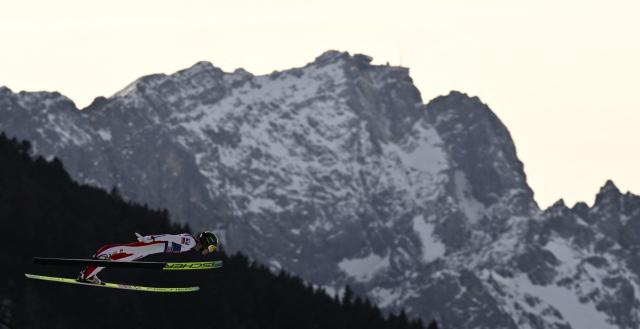 Austria's Jonas Schuster competes during the Men's Individual Large Hill HS142 event of the FIS Ski Jumping World Cup, the second leg of the Four Hills Tournament, in Garmisch-Partenkirchen, southern Germany on January 1, 2026. (Photo by PHILIPP GUELLAND / AFP)