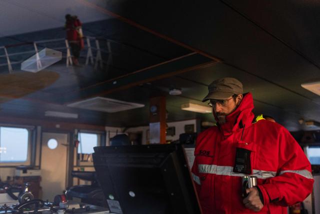 Search and Rescue (SAR) team leader of the migrants rescue ship "Ocean Viking" operated by the NGO SOS Mediterranee, takes part in a patrol at the search-and-rescue zone of the international waters between Malta and Tunisia, on December 31, 2025. (Photo by Sameer Al-DOUMY / AFP)