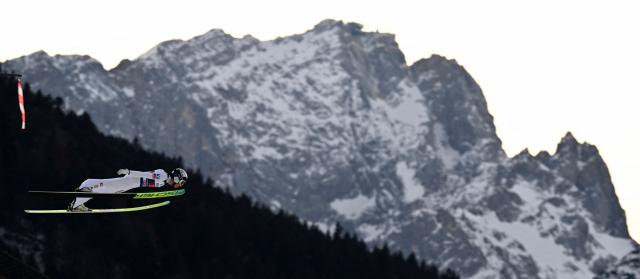Austria's Stephan Embacher competes during the Men's Individual Large Hill HS142 event of the FIS Ski Jumping World Cup, the second leg of the Four Hills Tournament, in Garmisch-Partenkirchen, southern Germany on January 1, 2026. (Photo by PHILIPP GUELLAND / AFP)
