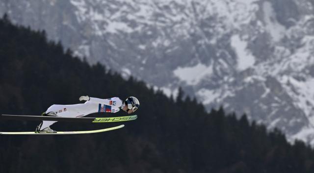 Austria's Stephan Embacher competes during the Men's Individual Large Hill HS142 event of the FIS Ski Jumping World Cup, the second leg of the Four Hills Tournament, in Garmisch-Partenkirchen, southern Germany on January 1, 2026. (Photo by PHILIPP GUELLAND / AFP)