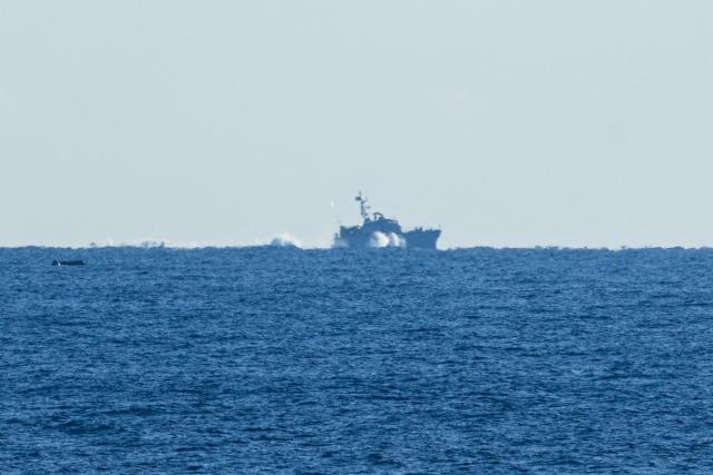This photograph shows a Libyan Coast Guard's boat sailing around the migrants rescue ship "Ocean Viking" operated by the NGO SOS Mediterranee, in the search-and-rescue zone of the international waters of Malta, on Januray 1, 2026. 33 migrants were rescued by crew members of the migrants rescue ship "Ocean Viking" operated by the NGO SOS Mediterranee. They had been stranded on the oil tanker the 'Maridive 703' since their initial rescue 5 days ago in the joint search zone between Malta and Tunisia in international Mediterranean waters. (Photo by Sameer Al-DOUMY / AFP)