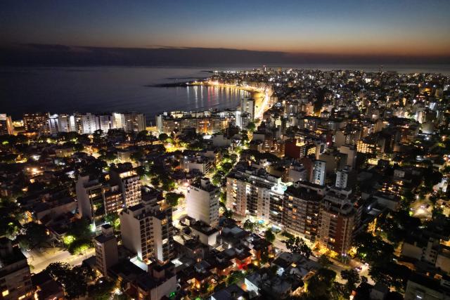 Aerial view of Montevideo and Pocitos Beach (L) taken on December 30, 2025. (Photo by Mariana SUAREZ / AFP)