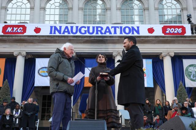 US Senator Bernie Sanders swears in New York mayor Zohran Mamdani as his wife Rama Duwaji holds the Koran during his public inauguration ceremony followed by a block party at City Hall in New York on January 1, 2026. Mamdani, the young upstart of the US left, was sworn in Thursday to take over as New York mayor for a term sure to see him cross swords with President Donald Trump. After the clocks struck midnight, bringing in 2026, Mamdani took his oath of office at an abandoned subway stop to begin managing the United States' largest city. He is New York's first Muslim mayor. (Photo by TIMOTHY A. CLARY / AFP)