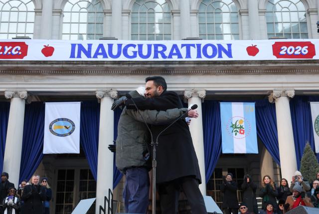 US Senator Bernie Sanders embraces New York mayor Zohran Mamdani after swearing him in during his public inauguration ceremony followed by a block party at City Hall in New York on January 1, 2026. Mamdani, the young upstart of the US left, was sworn in Thursday to take over as New York mayor for a term sure to see him cross swords with President Donald Trump. After the clocks struck midnight, bringing in 2026, Mamdani took his oath of office at an abandoned subway stop to begin managing the United States' largest city. He is New York's first Muslim mayor. (Photo by TIMOTHY A. CLARY / AFP)