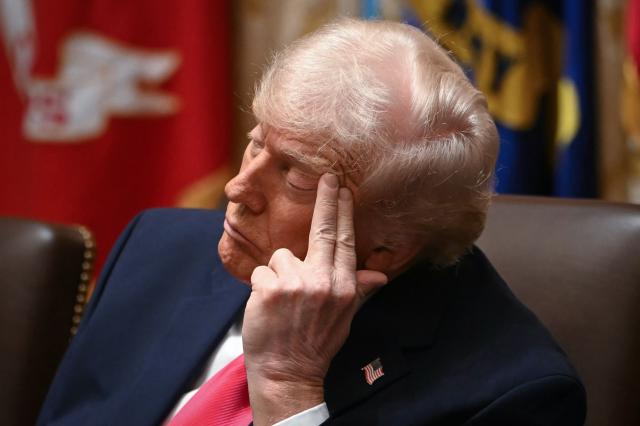 (FILES) US President Donald Trump attends a Cabinet Meeting in the Cabinet Room of the White House in Washington, DC on December 2, 2025. Trump blamed aspirin for large bruises on his hand and denied falling asleep while attending public meetings in an interview with The Wall Street Journal published on January 1, 2026. In the interview defending his health, Trump also changed his previous statement about receiving an MRI scan in October, saying it was instead a quicker CT scan. (Photo by ANDREW CABALLERO-REYNOLDS / AFP)