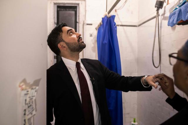 New York Mayor Zohran Mamdani visits the apartment of Nadege Romulus (R) in the Prospect Lefferts Gardens neighborhood of Brooklyn, New York, January 1, 2026, on his first day in office. Mamdani, the young upstart of the US left, was sworn in January 1 to take over as New York mayor for a term sure to see him cross swords with President Donald Trump. After the clocks struck midnight, bringing in 2026, Mamdani took his oath of office at an abandoned subway stop to begin managing the United States' largest city. He is New York's first Muslim mayor. (Photo by Dave Sanders / POOL / AFP)
