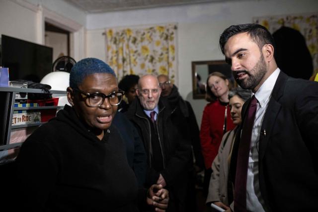 New York Mayor Zohran Mamdani speaks with Nadege Romulus (L) as he visits her apartment in the Prospect Lefferts Gardens neighborhood of Brooklyn, New York, January 1, 2026, on his first day in office. Mamdani, the young upstart of the US left, was sworn in January 1 to take over as New York mayor for a term sure to see him cross swords with President Donald Trump. After the clocks struck midnight, bringing in 2026, Mamdani took his oath of office at an abandoned subway stop to begin managing the United States' largest city. He is New York's first Muslim mayor. (Photo by Dave Sanders / POOL / AFP)