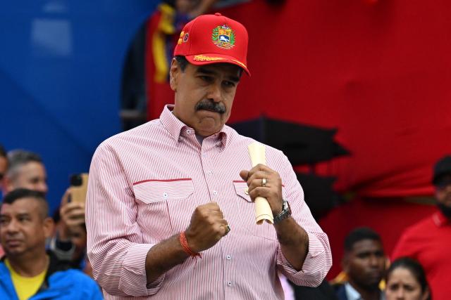 (FILES) Venezuela's President Nicolas Maduro dances during a rally in Caracas on December 1, 2025. In an interview on January 1, 2026, Venezuelan President Nicolás Maduro avoided confirming or denying an alleged attack on a narcotics facility that, according to Donald Trump, the United States recently carried out on Venezuelan territory. (Photo by Juan BARRETO / AFP)