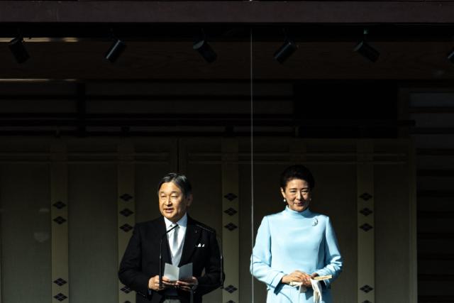 Japan's Emperor Naruhito (L) gives a speech with Empress Masako during the traditional New Year's greeting ceremony by Japan's royal family at the Imperial Palace in Tokyo on January 2, 2026. (Photo by Philip FONG / AFP)